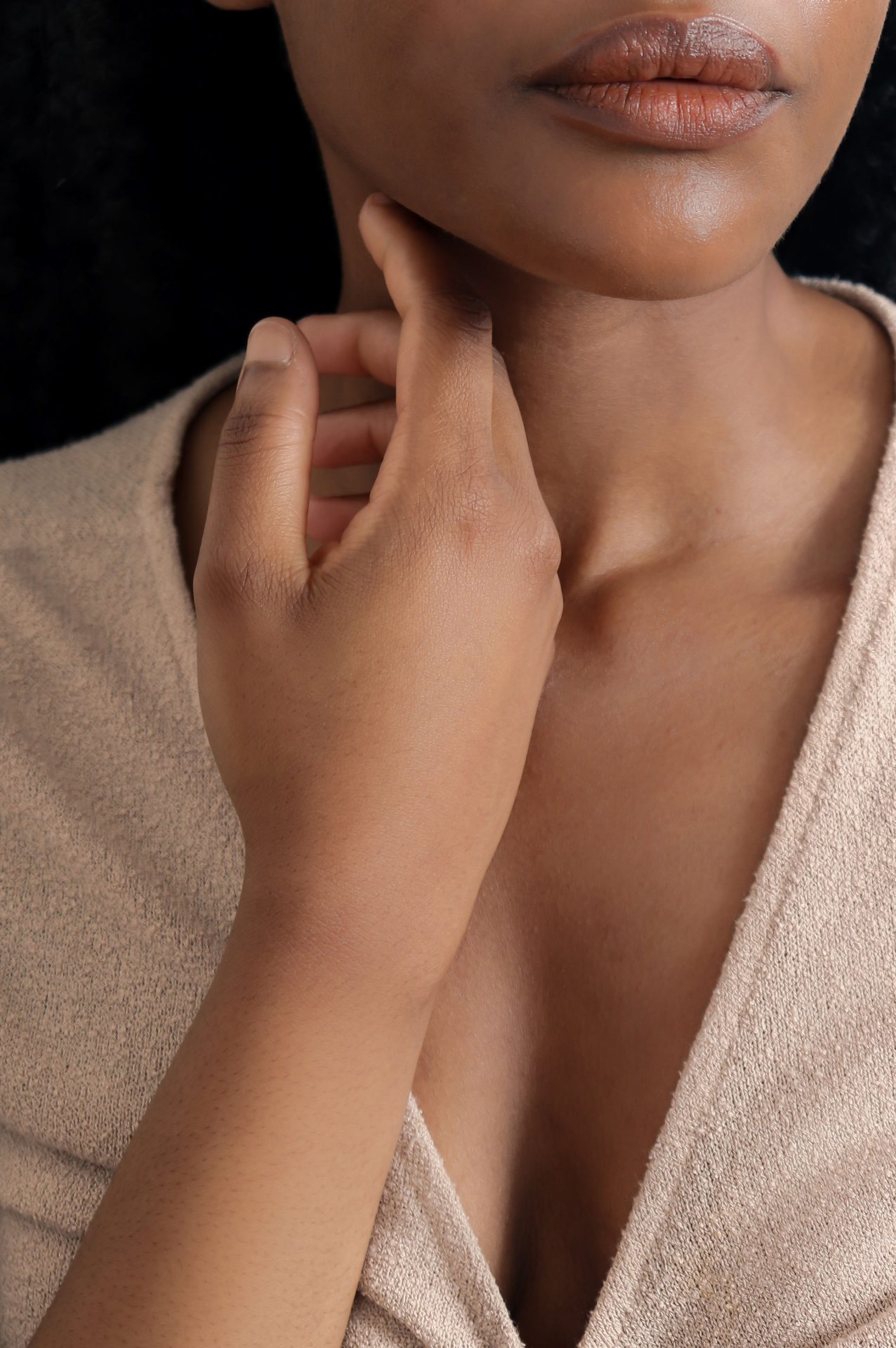 Beautiful woman holding hand to face