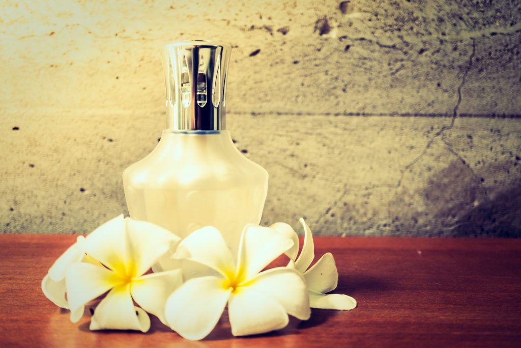 perfume bottle surrounded by vanilla flowers