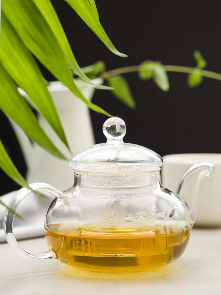 green tea in a glass teapot